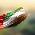 Flag of Sudan waving in the wind against a blurred background