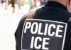 Close-up of a police officer's back with a 'POLICE ICE' badge
