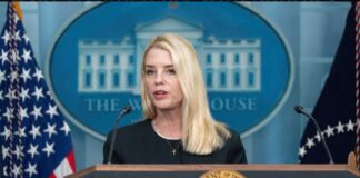 A government official speaking at a podium in front of the White House seal