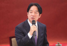 A man speaking into a microphone indoors