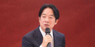 A man speaking into a microphone indoors