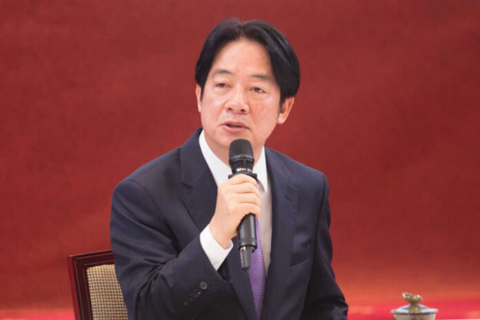 A man speaking into a microphone indoors