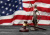 Decades-Old Shootdown Mystery—Will Justice Finally Prevail? Lady Justice statue and judge’s gavel before a US flag