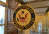 US House of Representatives seal on glass door