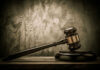 Judges gavel on a dark wooden surface.