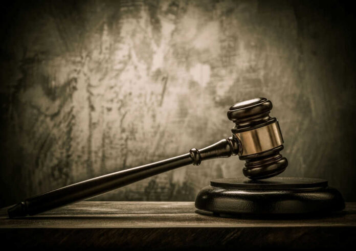 Judges gavel on a dark wooden surface.
