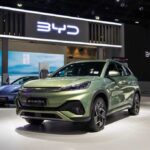 China’s EV Push Sparks Security Fears A green BYD Atto 3 electric vehicle displayed at a car exhibition
