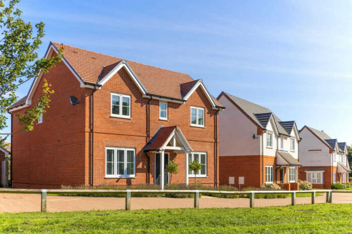 buildnewhomeid2344884495jpg Red-brick suburban house in a sunny neighborhood.
