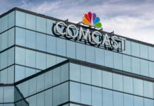 Comcast’s Bold Gamble Signals Bigger Changes Glass building featuring Comcast logo with NBC peacock symbol