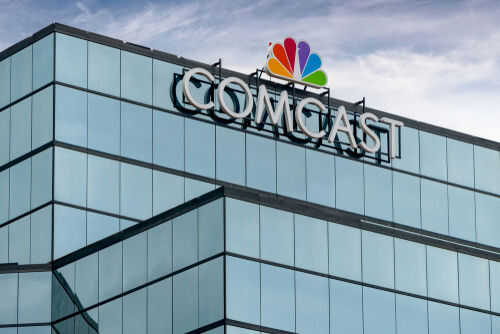 Glass building featuring Comcast logo with NBC peacock symbol