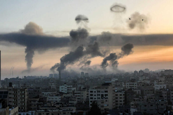 israelstrikesid1972326752jpg Smoke rising over cityscape at sunset; two birds flying.