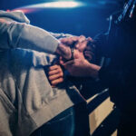 Handcuffed While Dying — Why? Police officer arresting a person at night.