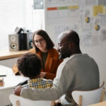 Could Family Conversations Become Legal Risks? Three people sitting at a desk talking together