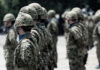 Soldiers in camouflage uniforms standing in formation