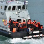 Border Force boat with migrants wearing life jackets