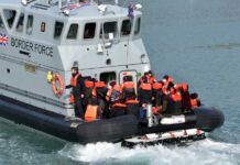 Border Force boat with migrants wearing life jackets