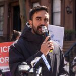 New York Expands SANCTUARY Shield Against ICE Man speaking into a microphone at a protest for senior justice