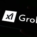 A smartphone screen displaying the Grok logo in white against a dark background