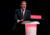 UK Government Tracking Gets An Upgrade A man in a suit speaking at a podium.
