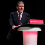 UK Government Tracking Gets An Upgrade A man in a suit speaking at a podium.