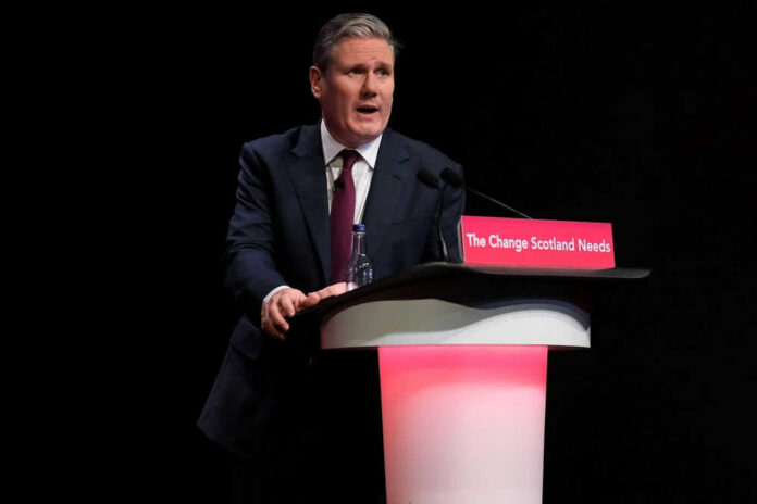A man in a suit speaking at a podium.