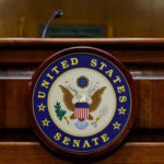 Vote-A-Rama Chaos Supercharges ICE United States Senate emblem on wooden podium