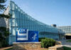 CDC Workforce Shrinks Amid Budget Fight CDC headquarters building with signage and blue sky