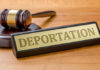 Trump Shirt Fight Ends In Deportation Case Gavel and sign reading Deportation on desk.