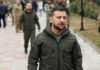 Ukraine’s Biggest Shake-Up Raises Hard Questions Zelensky walking outdoors with military personnel nearby.
