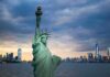 Record Welfare Spending Demands Accountability Statue of Liberty with city skyline at dusk