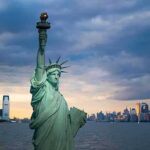 Record Welfare Spending Demands Accountability Statue of Liberty with city skyline at dusk