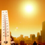 When Heat Turns Deadly, Questions Follow Thermometer displaying high temperature against a sunset city skyline