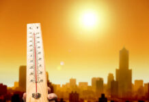 When Heat Turns Deadly, Questions Follow Thermometer displaying high temperature against a sunset city skyline
