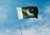 Pakistan flag waving against a blue sky