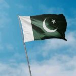 Pakistan flag waving against a blue sky