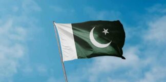 Pakistan flag waving against a blue sky