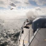 America’s Next Pacific Move Starts Here Naval ship firing a weapon into the ocean with a plane flying overhead