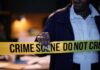 Influencer Ambush Sparks Wild Rumors Police officer holding crime scene tape