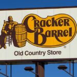 Cracker Barrel roadside sign with logo against blue sky