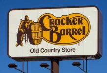 Cracker Barrel roadside sign with logo against blue sky