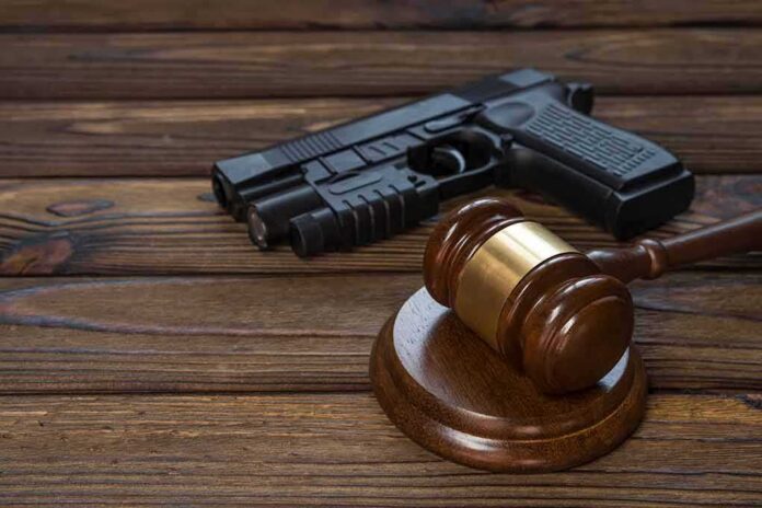 Gavel and handgun on wooden table