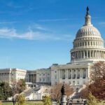 United States Capitol building with dome and autumn trees