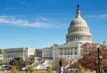 United States Capitol building with dome and autumn trees