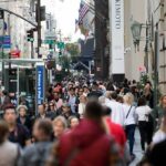 Crowd of pedestrians on a busy city sidewalk