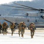 Risky Gamble? U.S.–Seoul Drills Shrink Soldiers disembark and walk past a large military helicopter