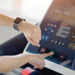 Wearables Funnel Into Hospital Files Person using a treadmill touchscreen with a smartwatch