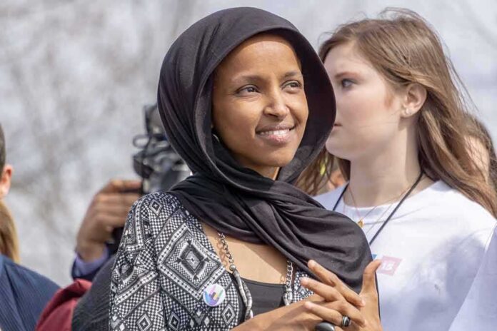 shutterstock_1340333447 woman in a black headscarf at an outdoor gathering