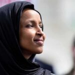 Minnesota’s Deep-Blue Stronghold Just Spoke Loudly Woman in black headscarf looking upward outdoors