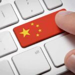 That “Made in USA” Label? Think Again Finger pressing keyboard key with China flag design