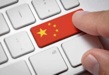 Finger pressing keyboard key with China flag design